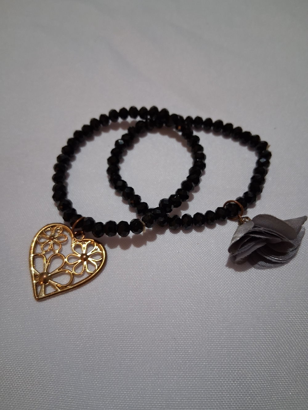 Black Beaded Stretch Bracelet with Gold Heart Charm and Gray Flower